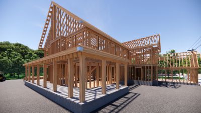 Wooden house framework under clear sky.