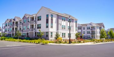 Modern apartment buildings with balconies on a sunny day.