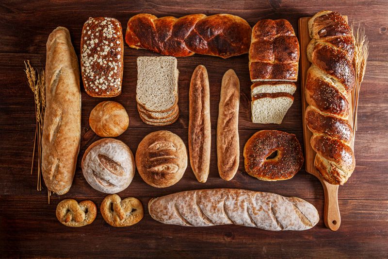 Artisanal bakery: Assortment of bread on rustic wooden table.