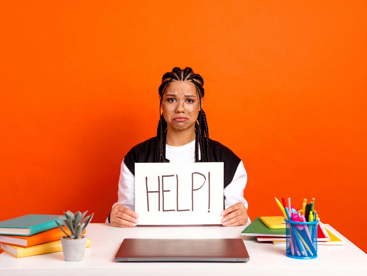 Woman holding help sign on the Ellet Consulting operations support & workflow optimization page