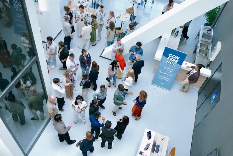 High-angle image showing real human interaction at scale. Suitable for themes like innovation, community, workplace culture, and collaboration.