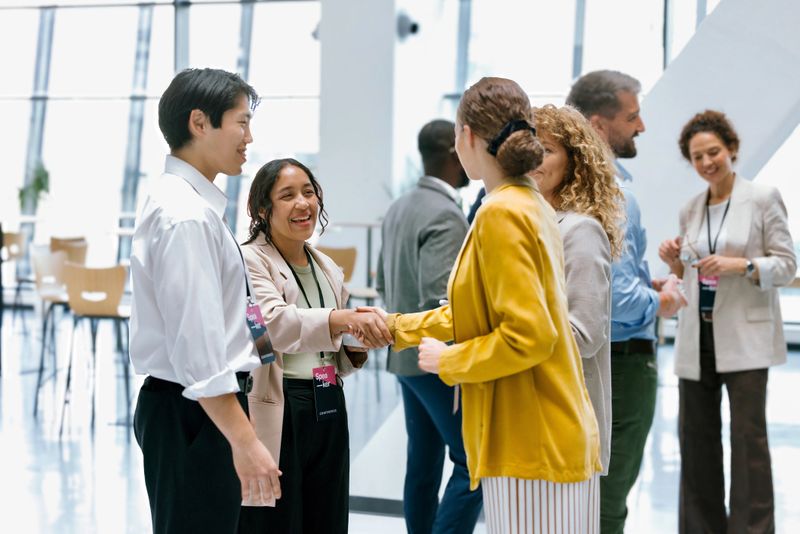 Diverse Business Colleagues Shaking Hands during Networking Event at Conference
