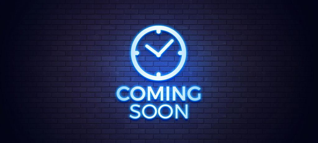 Blue neon "Coming Soon" sign with clock on brick wall.