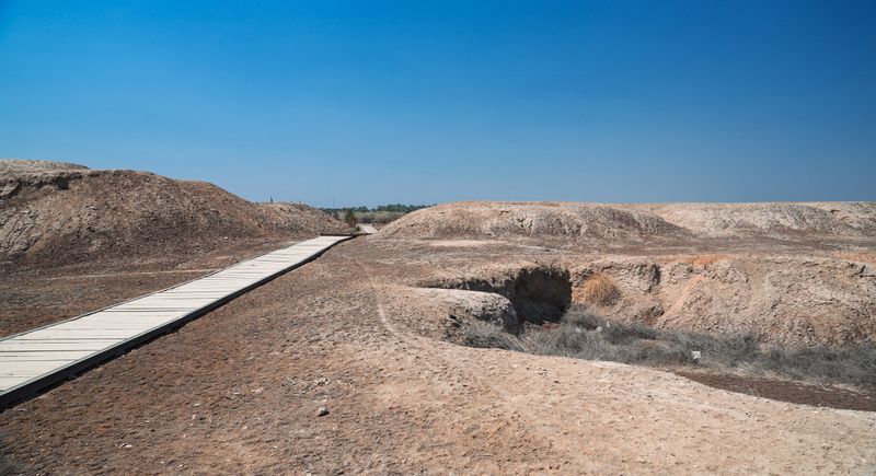 Visitors explore the Kish archaeological site in Iraq as they discover remnants of ancient civilization and historical landscapes.