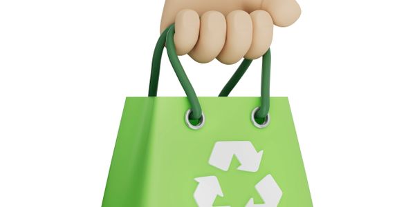 Hand holding a green recycling bag with a recycling symbol.