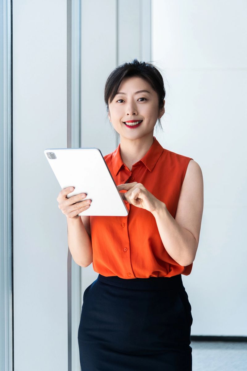 Businesswoman using digital tablet near the window