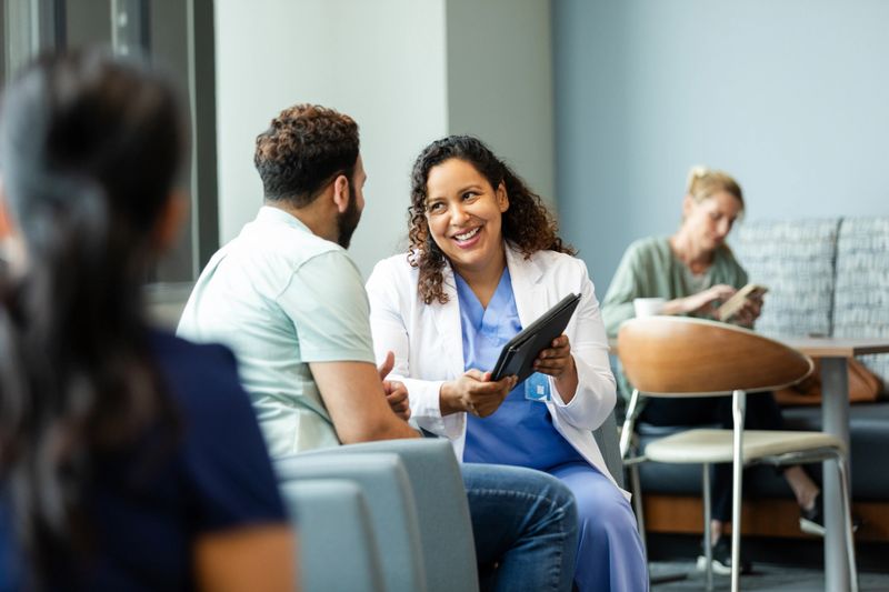 Female doctor uses digital tablet during patient consultation.  Healthcare and medicine, mental health.