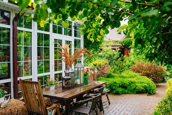 Cozy outdoor dining area surrounded by lush greenery.