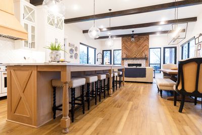 Remodeled kitchen in modern colors and accents. Large wood island with white wall cabinetry.