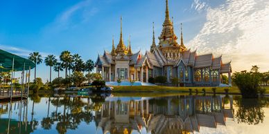 Thai temple reflected in the lake in front of it