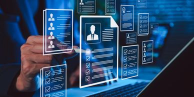 Digital resume and profile selection on a laptop screen.