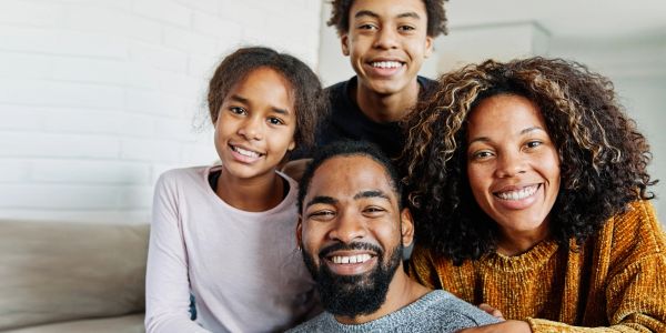 Happy family smiling together indoors.
