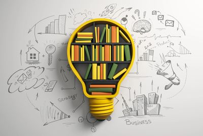 Light bulb bookshelf filled with colorful books and business doodles around.