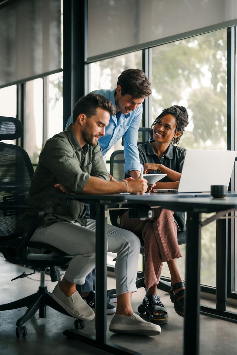 Group of busy happy diverse professional business team people working in office using digital tablet. Multiethnic young startup team working on a project together