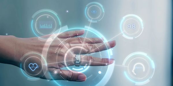 Hand wearing a smart ring displaying futuristic health and data holograms.