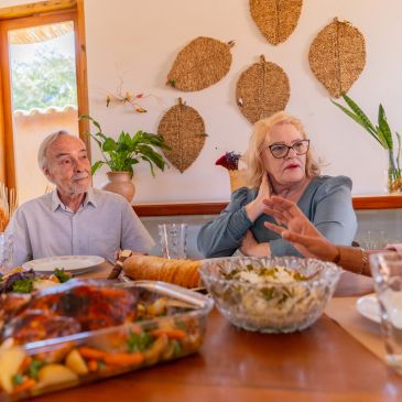 Elderly couple having a meal and conversation.
