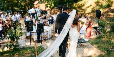 Bride and groom walking at outdoor wedding.