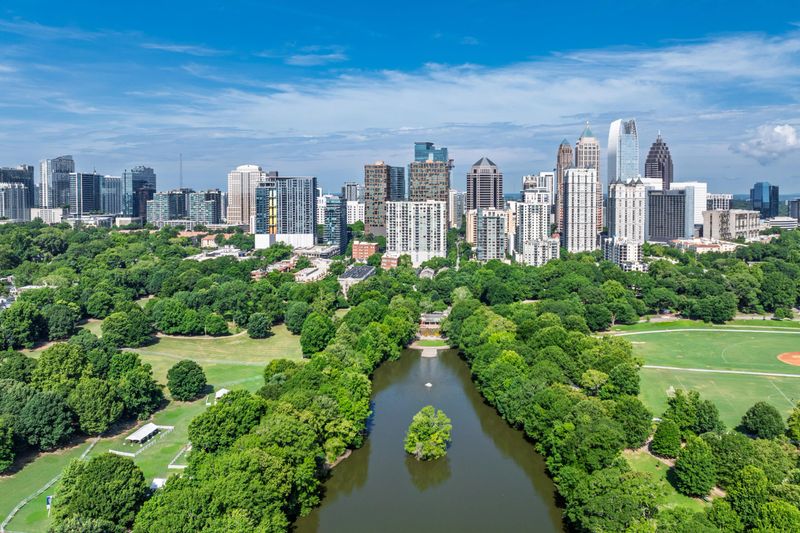 Drone angle view of Atlanta Georgia skyline with Piedmont Park and lake in the foreground.