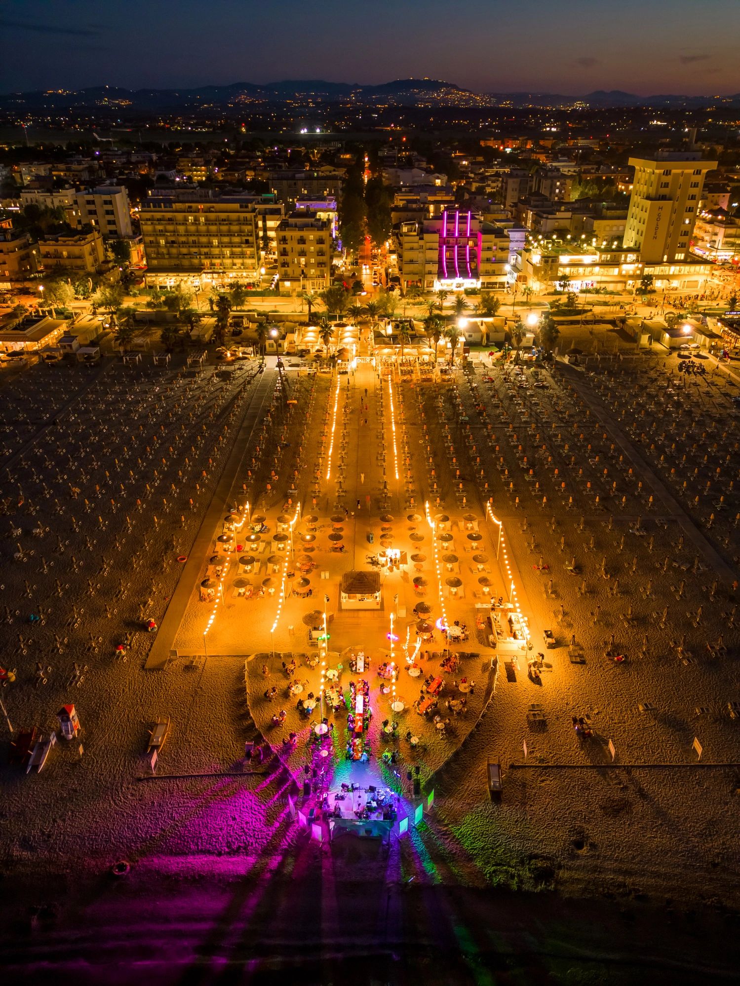 Vibrant nightlife on Adriatic beach in Rimini, Italy summer vacation.