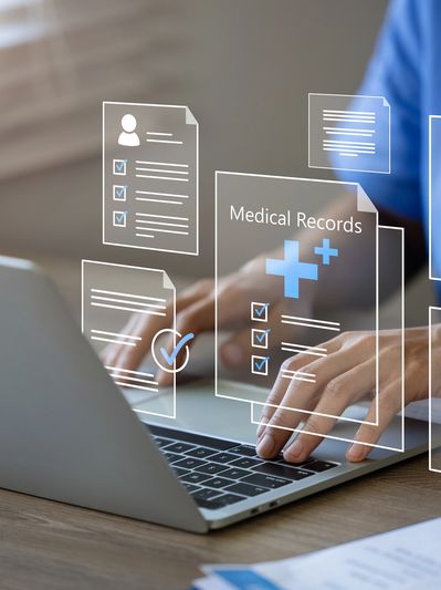 Person accessing digital medical records on a laptop.