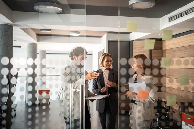 Business team engaged in a lively discussion within a modern office space, brainstorming and exchanging innovative ideas for their upcoming project while fostering collaboration and teamwork