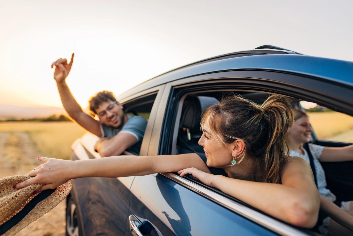 Stack of books next to pencils in a holder and a camera.