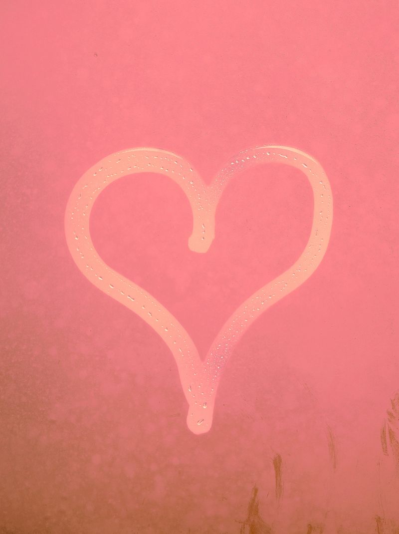A heart shape drawn by hand on a misted window, with visible condensation droplets. The concept is repeated in multiple color backgrounds — gray, yellow, green, blue, and pink — creating a visually co