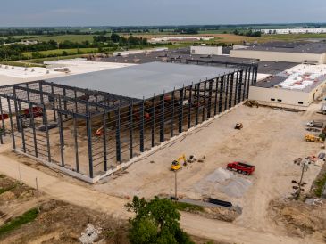 Construction site of large industrial building with steel frame.