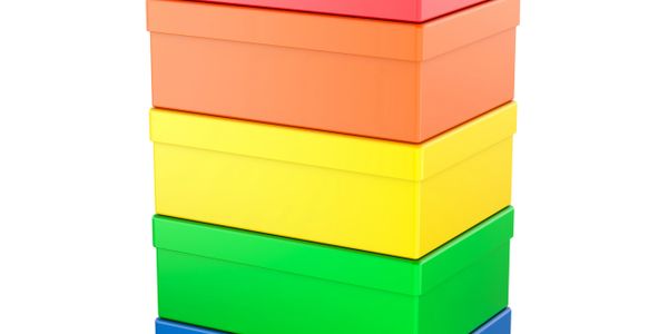 Stack of colorful rectangular storage boxes in rainbow order.
