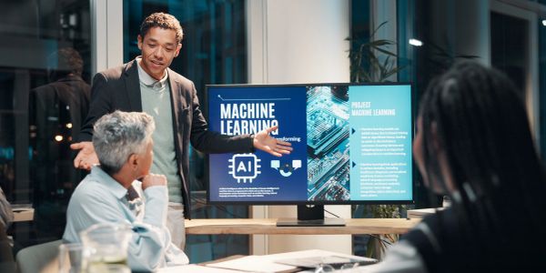 Person presenting machine learning project to colleagues.