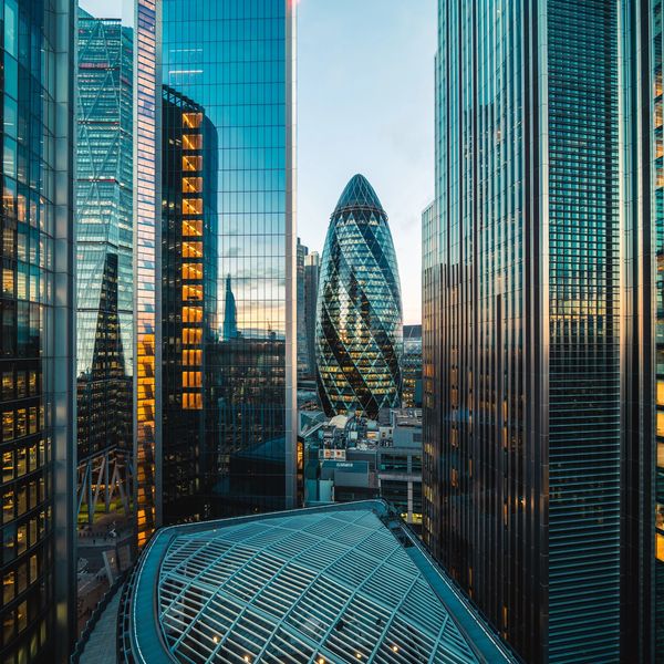 Sunset view of London skyscrapers with the iconic Gherkin building at the center.