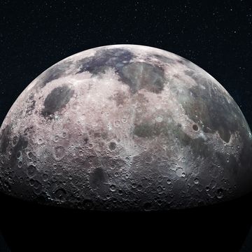 Close-up view of the moon's cratered surface against a starry sky.