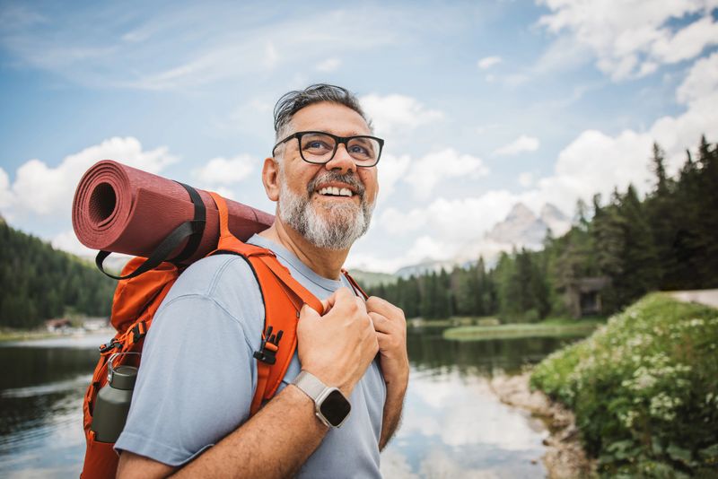 Mature man with backpack hiking at Dolomite.