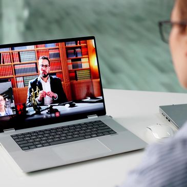 Person attending a virtual meeting on laptop.