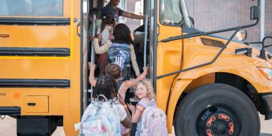 Children boarding a yellow school bus.