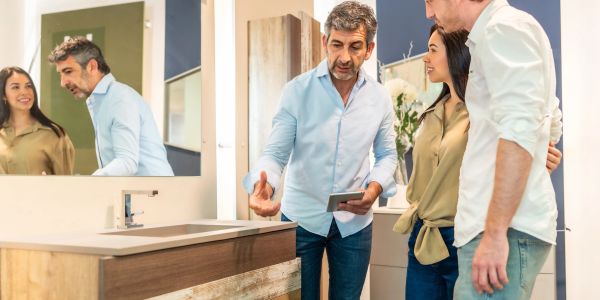 Couple consulting a salesperson about a bathroom sink.