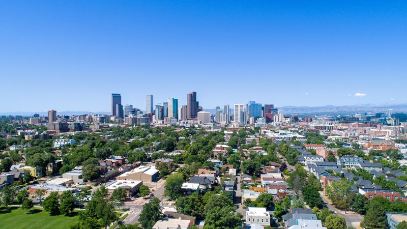 Aerial view of the Denver, Colorado skyline and the Rocky Mountains in June