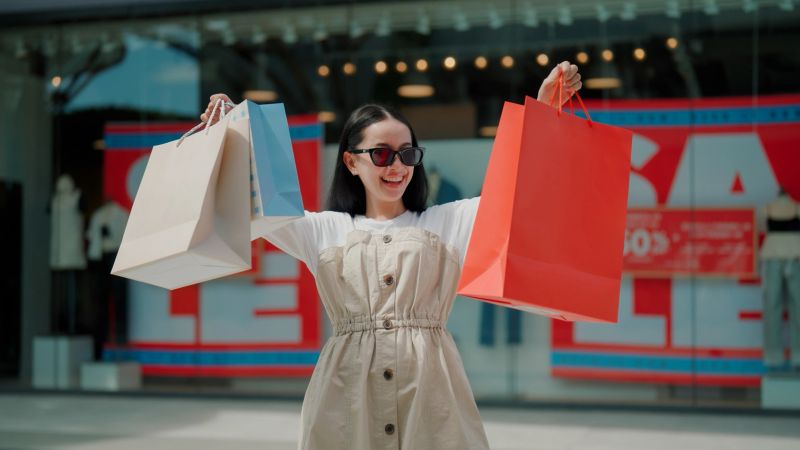 A young Asian woman shopping for items on sales during Black Friday.