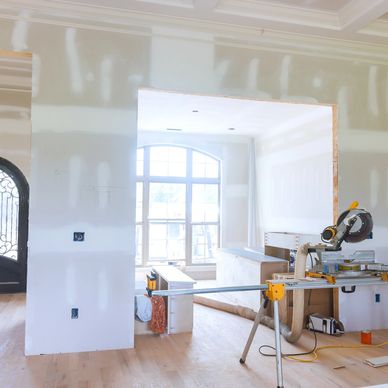 Interior of a house under renovation with tools and unfinished walls.