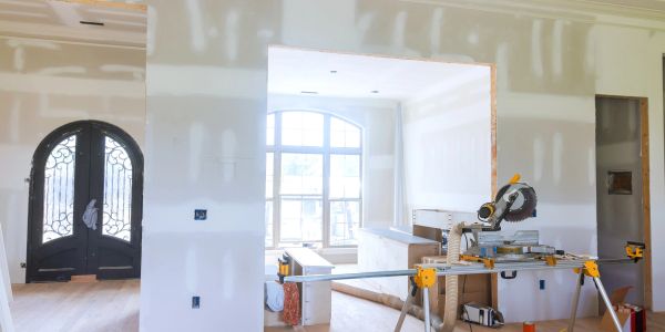 Room under renovation with construction tools and unfinished walls.