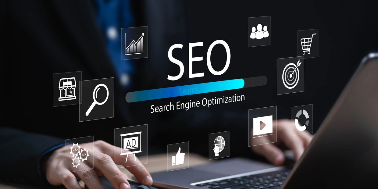 Acronym SEO. Search Engine Optimization below it. Man on his laptop computer—several SEO emojis.