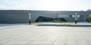 Modern minimalist building with open plaza.