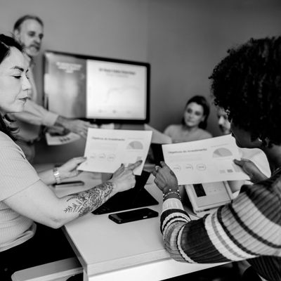 Team discussing documents with charts in a meeting.