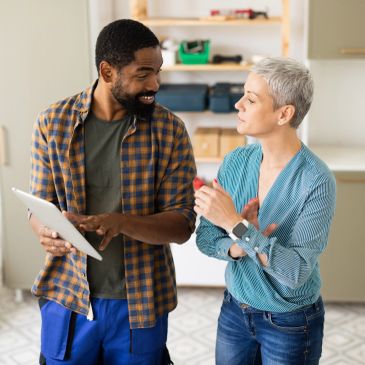 Two people discussing something on a tablet.