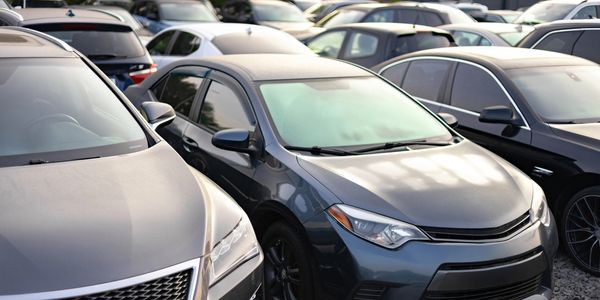 A crowded parking lot filled with parked cars.