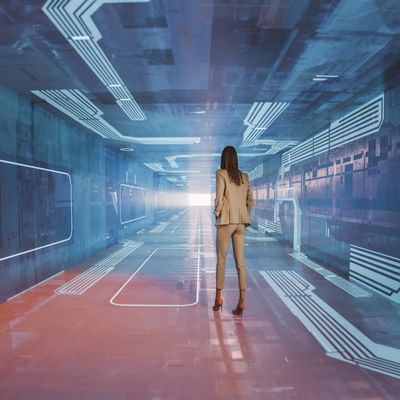 Woman stands in futuristic corridor with glowing lines and digital effects.