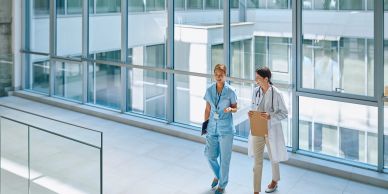 Doctors walking and talking in a hospital corridor.