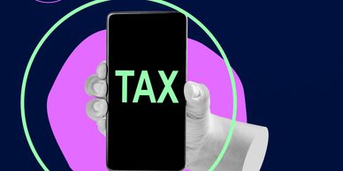 Hand holding phone displaying "TAX" with money bag icon on dark background.