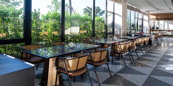 Sunlit modern dining area with cross contact dining, glass tables, accell clean,  large windows. Accell clean sydney