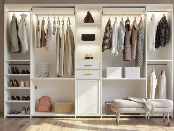 Organized white wardrobe with clothes, shoes, and accessories.
